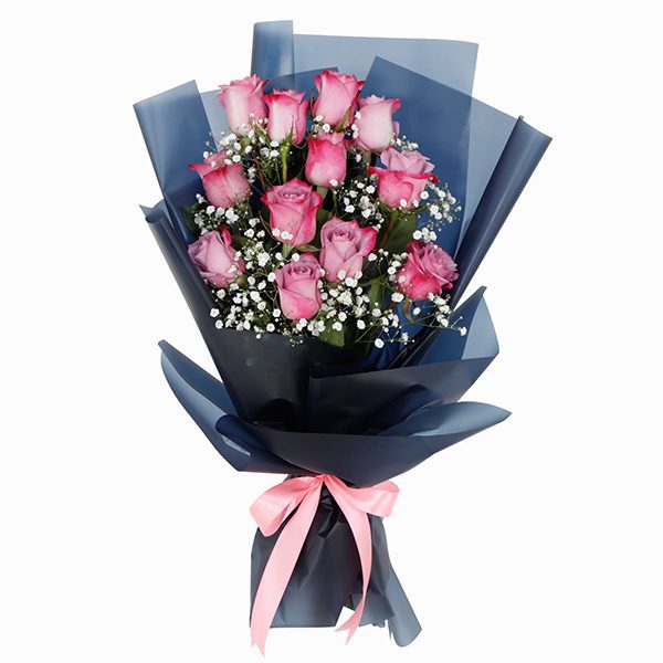 Designer Bouquet of 12 Purple Roses A bouquet of 12 purple roses complemented by baby's breath wrapped in tissue floral wraps tied with a pink ribbon.