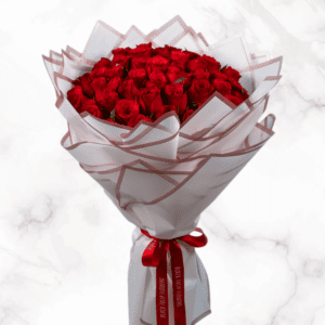 Stunning red rose bouquet wrapped in sleek cellophane with shimmering gold borders.