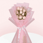 Enjoy this hand-tied 8 pink rose and gypso bouquet wrapped in Korean style flower wrapping sheets with white ribbon