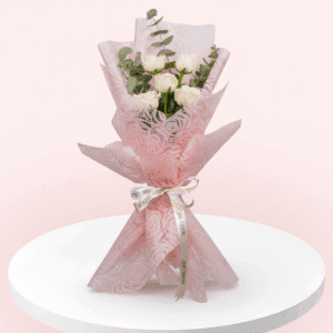 5 white roses handtied in a bouquet with eucalyptus and Korean wrap