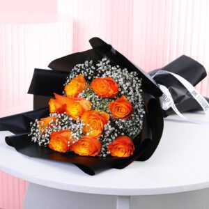 A bouquet of orange rose bouquet wrapped in black paper